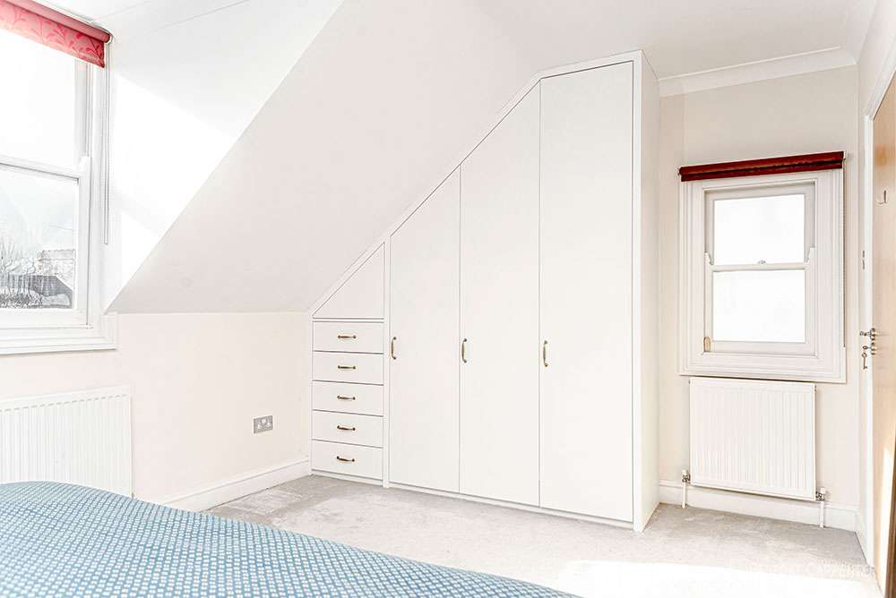 Fitted storage unit made with MDF wood for a house in New Oxford Street